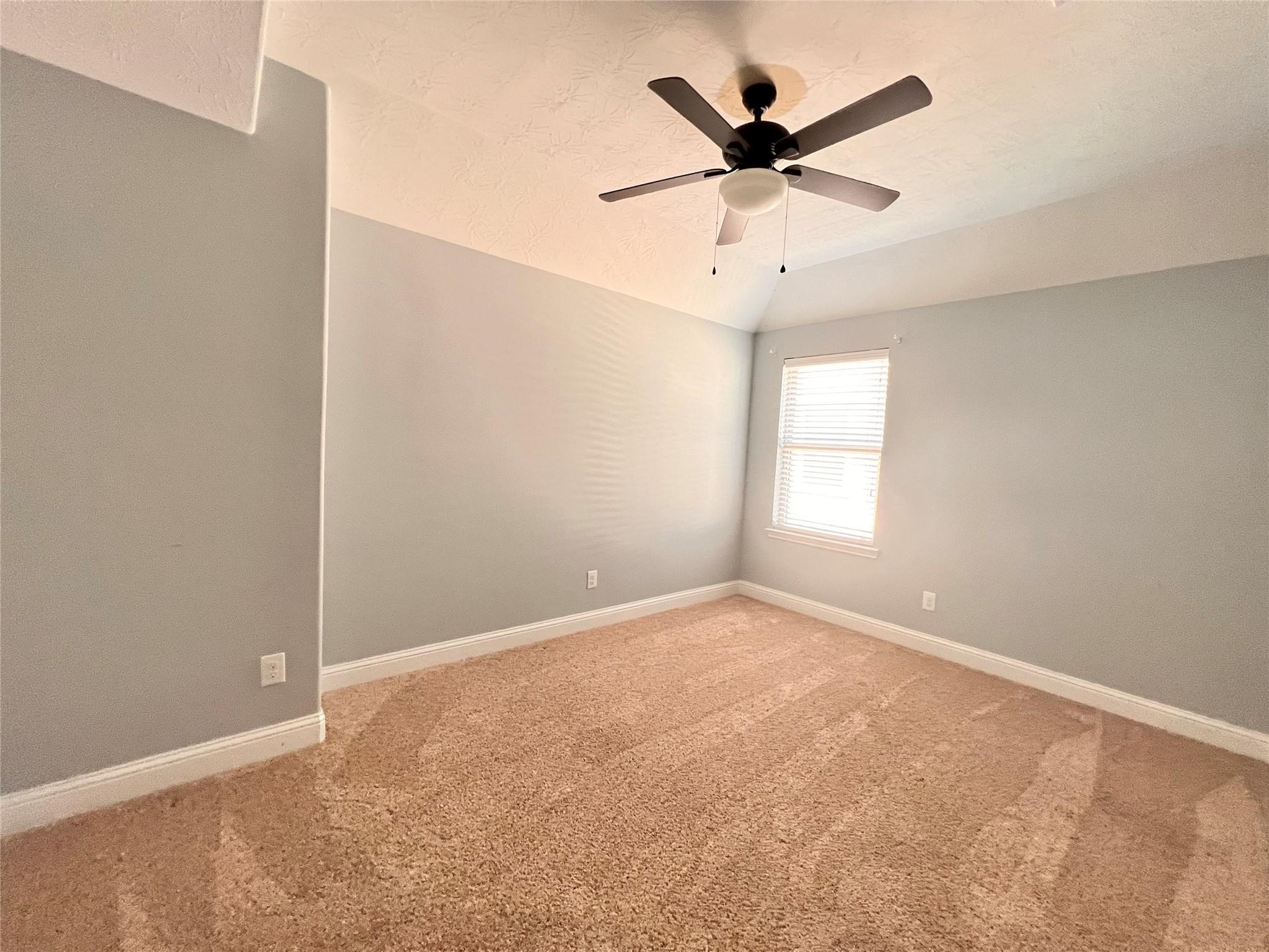 26842 Trinity Trail Cypress, TX 77433 - Photo 26 of 31 an empty room with ceiling fan and window