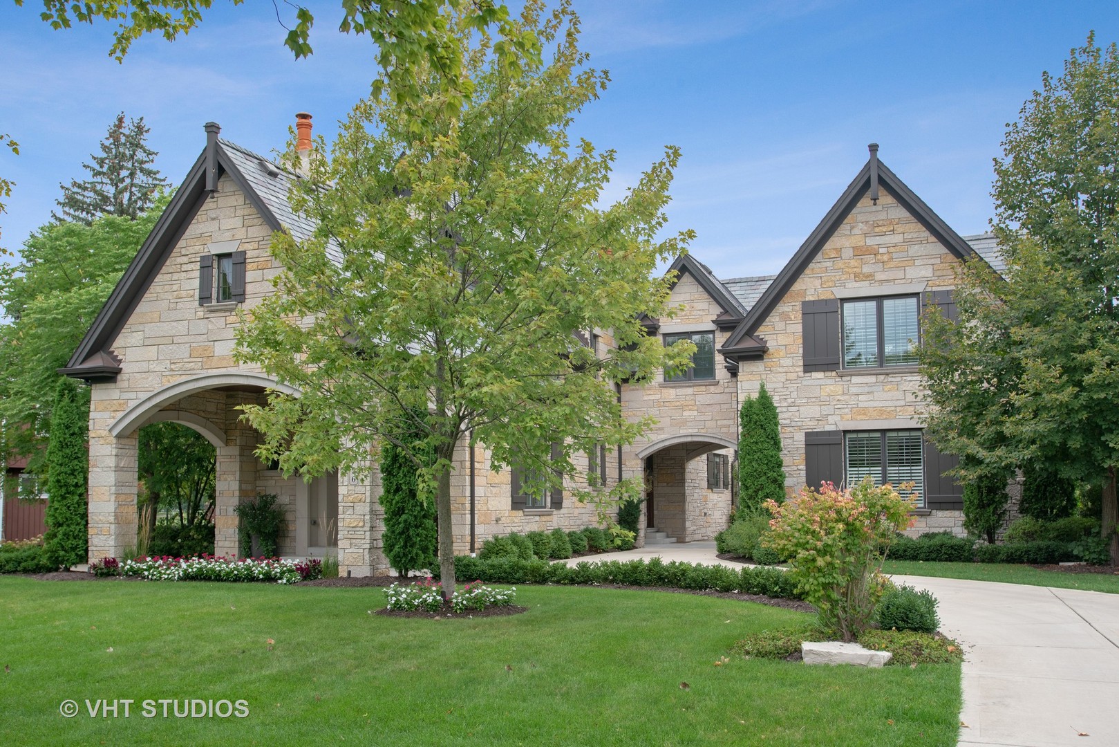 a front view of a house with a garden