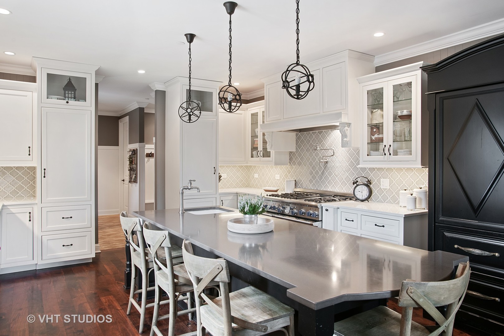 726 Hastings Street Park Ridge, IL 60068 - Photo 8 of 38 a kitchen with stainless steel appliances granite countertop a stove a refrigerator a oven a dining table and chairs with wooden floor