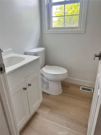 a bathroom with a toilet a sink and a window