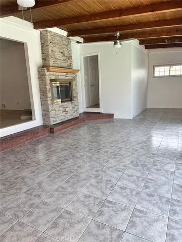 a view of an empty room with a fireplace