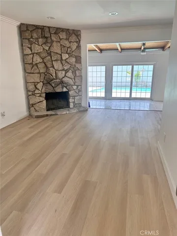 a view of empty room with a fireplace