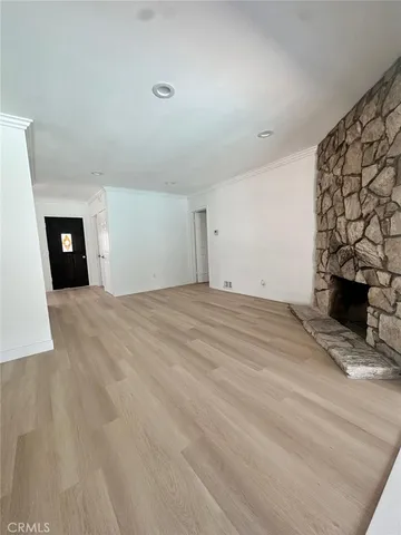 a view of an empty room with a fireplace