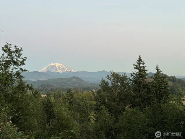 a view of a town with mountains in the background