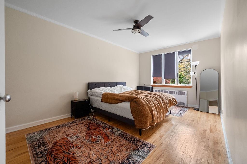 38 Corbin Place Brooklyn, NY 11235 - Photo 14 of 31 a bedroom with a bed and wooden floor