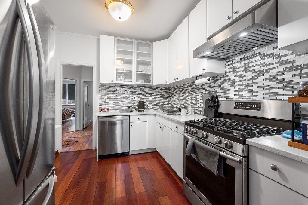 38 Corbin Place Brooklyn, NY 11235 - Photo 16 of 31 a kitchen with stainless steel appliances granite countertop a stove and a refrigerator