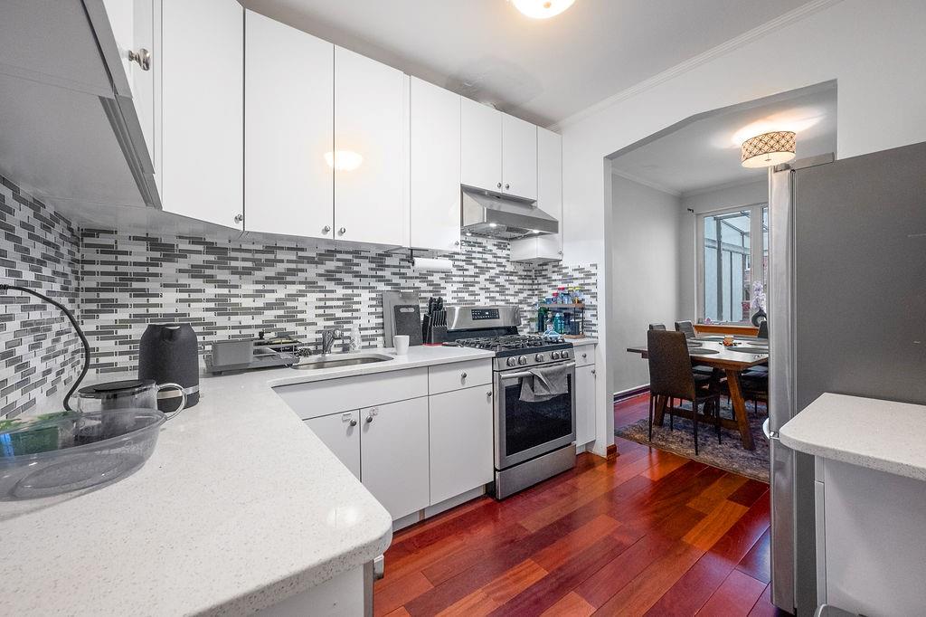38 Corbin Place Brooklyn, NY 11235 - Photo 17 of 31 a kitchen with a sink appliances and cabinets