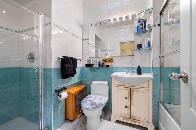 a bathroom with a sink toilet and shower