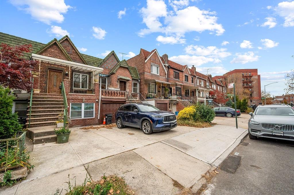 38 Corbin Place Brooklyn, NY 11235 - Photo 29 of 31 a car parked in front of a white house