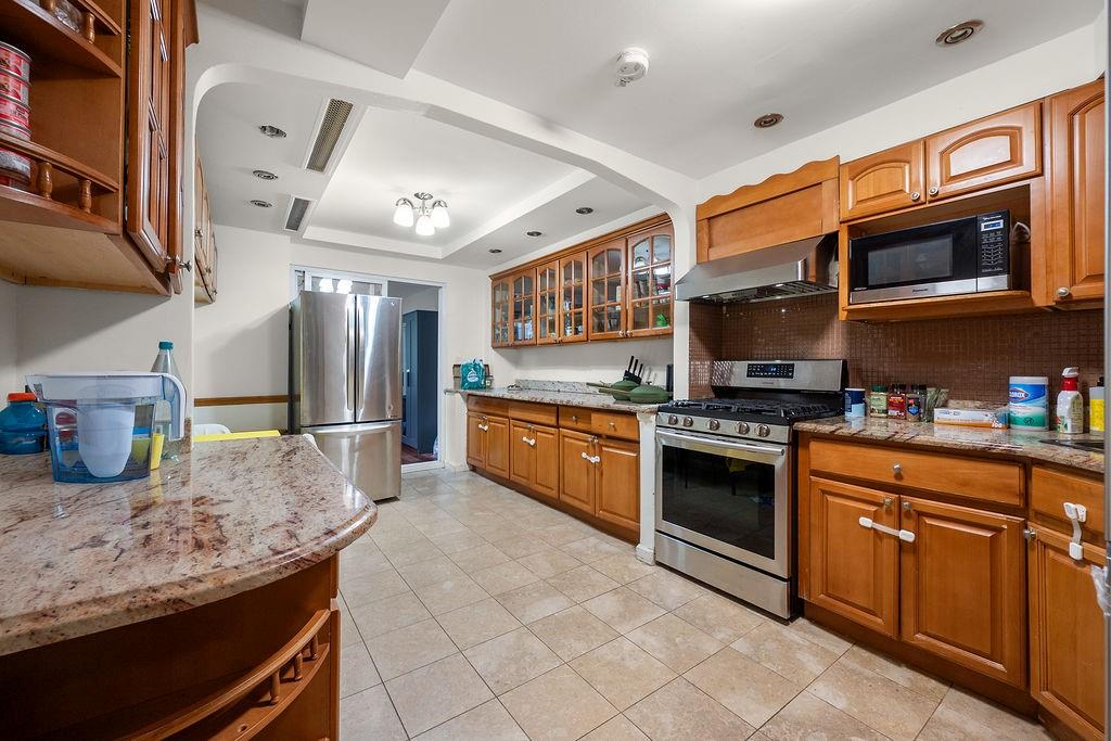 38 Corbin Place Brooklyn, NY 11235 - Photo 4 of 31 a kitchen with stainless steel appliances granite countertop a stove top oven a sink and dishwasher