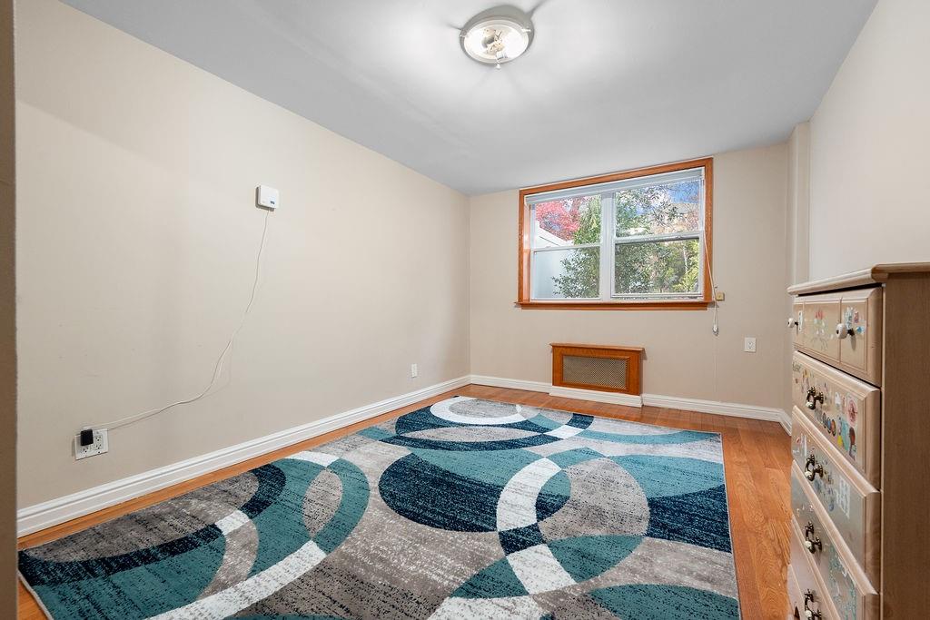 38 Corbin Place Brooklyn, NY 11235 - Photo 7 of 31 a bedroom with a bed and a window