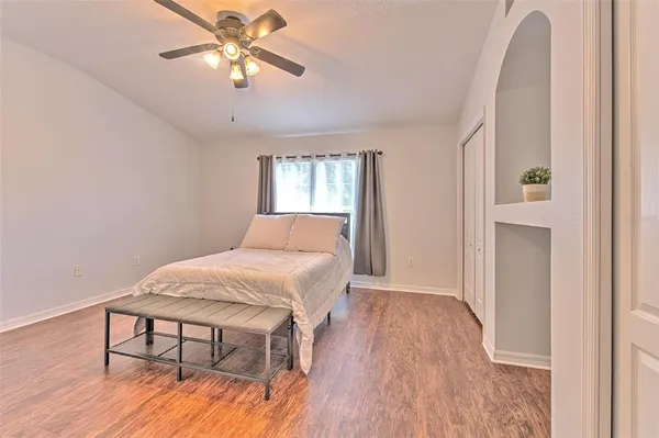a bedroom with a bed and a chandelier