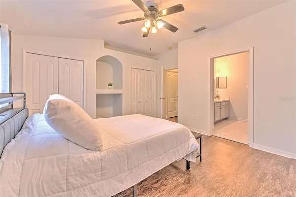 a bedroom with a bed and a chandelier