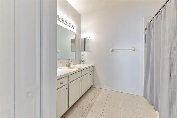 a bathroom with a double vanity sink and a mirror