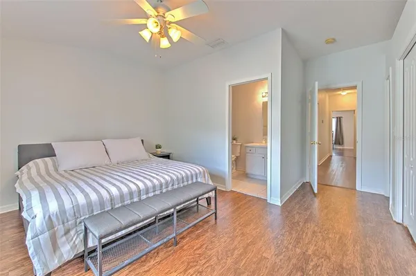 a bedroom with a bed and a chandelier