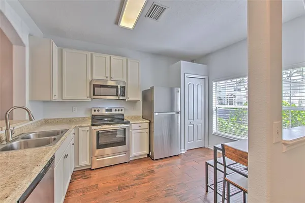 a kitchen with a stove a sink and a microwave