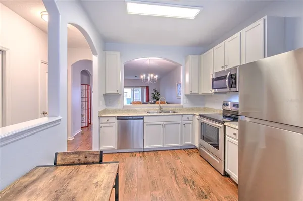 a kitchen with granite countertop stainless steel appliances and wooden cabinets