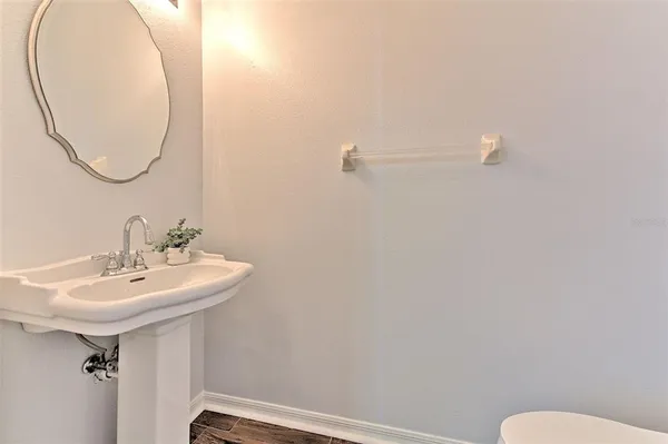 a bathroom with a sink a mirror and a toilet