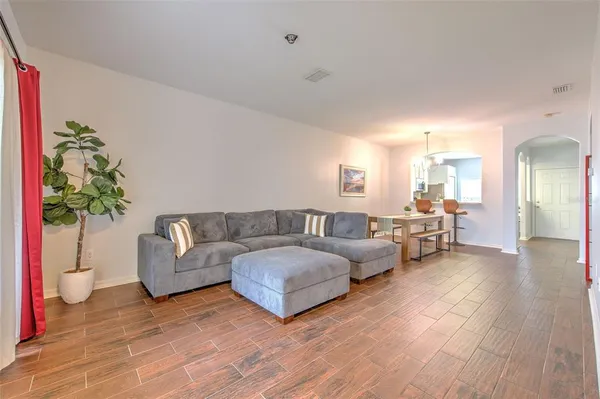 a living room with furniture and a potted plant