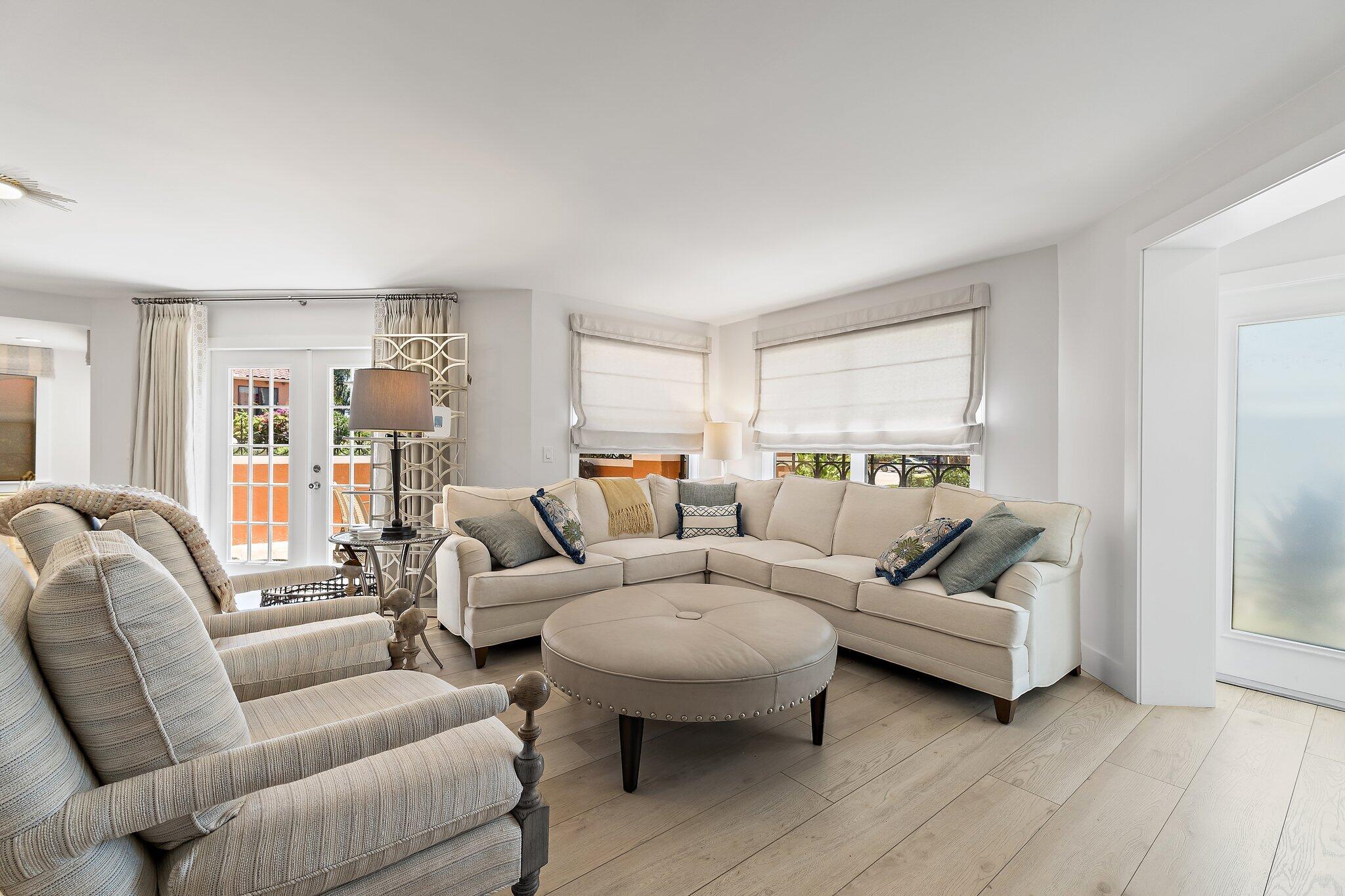 15 Uno Lago Drive, Unit 15 Juno Beach, FL 33408 - Photo 11 of 50 a living room with furniture and a large window