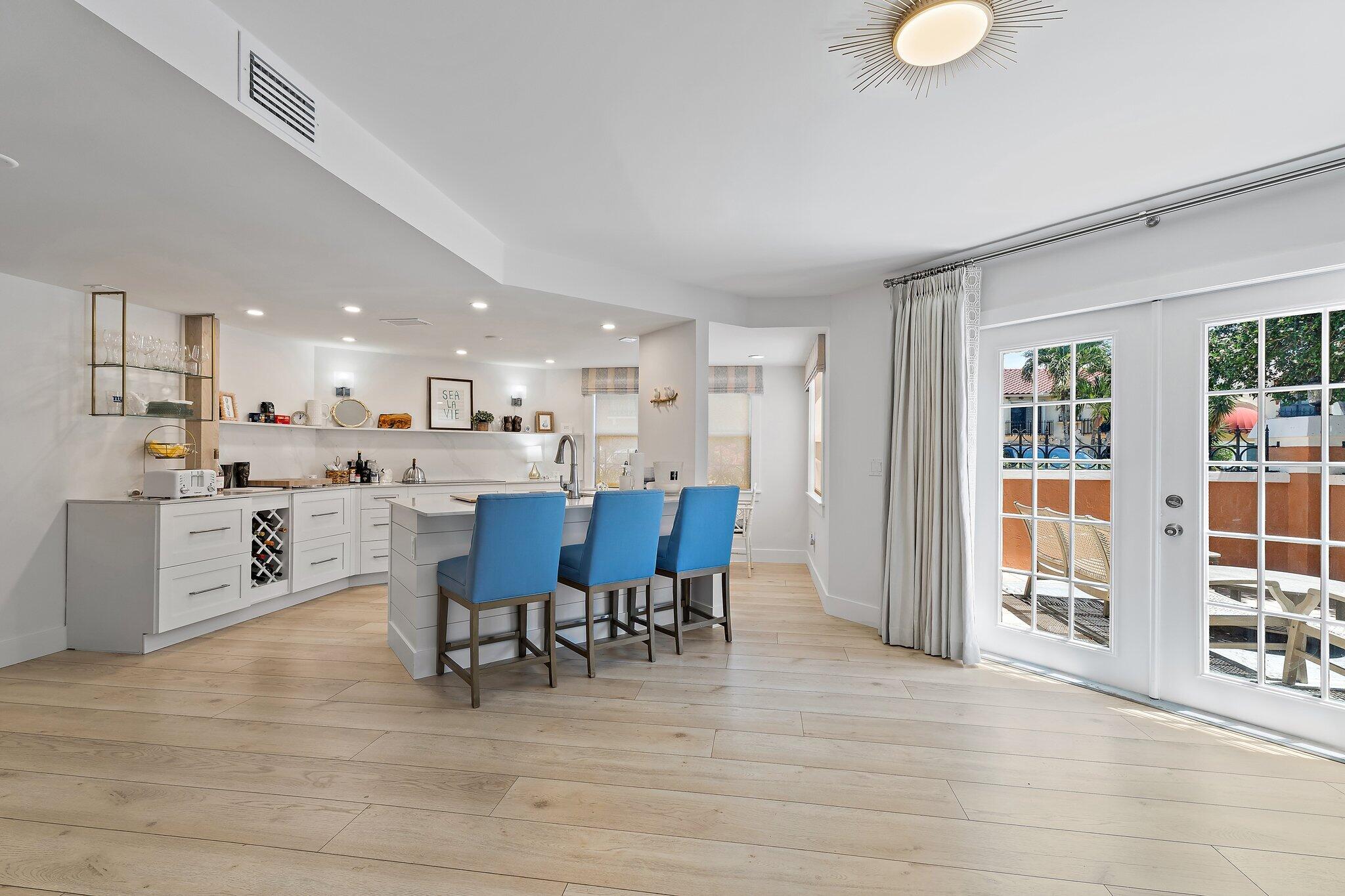 15 Uno Lago Drive, Unit 15 Juno Beach, FL 33408 - Photo 13 of 50 a view of a dining room with furniture and chandelier