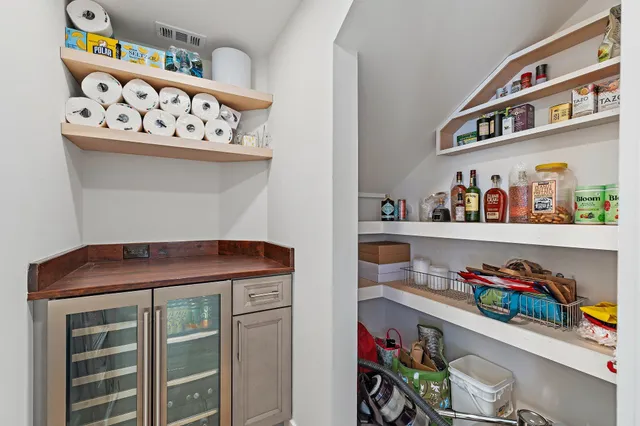 a utility room with lots of clutter and cabinets