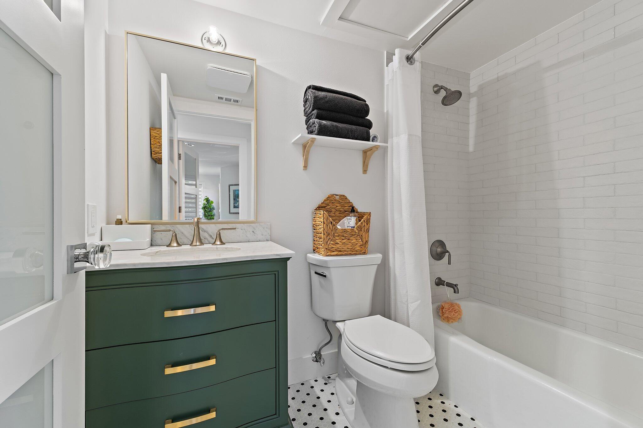 15 Uno Lago Drive, Unit 15 Juno Beach, FL 33408 - Photo 23 of 50 a bathroom with a toilet sink and mirror