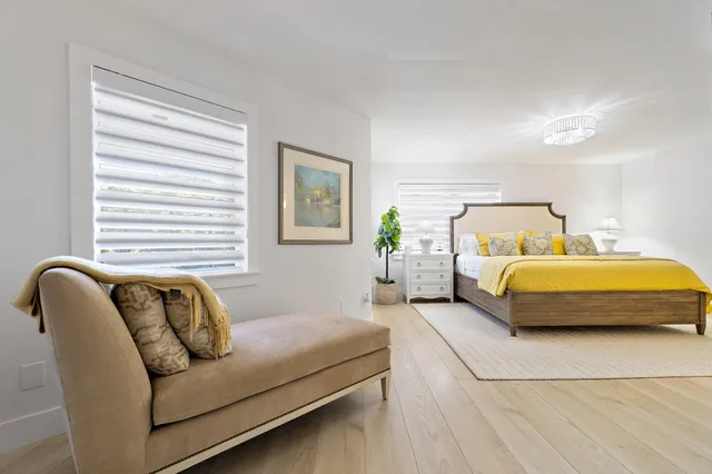 a bedroom with a bed couch and window