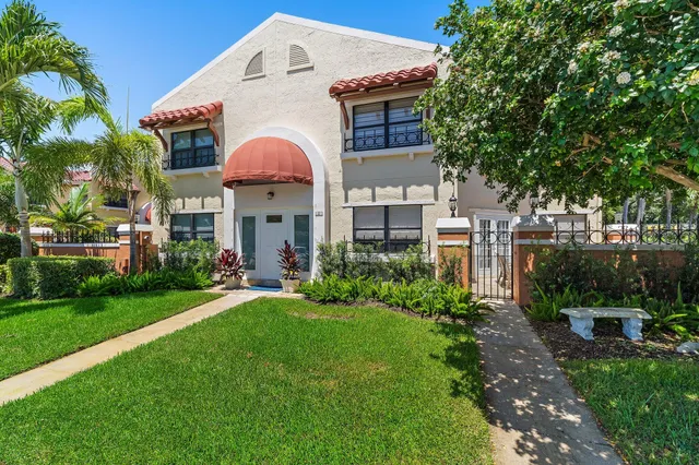 a view of a house with a yard and sitting area