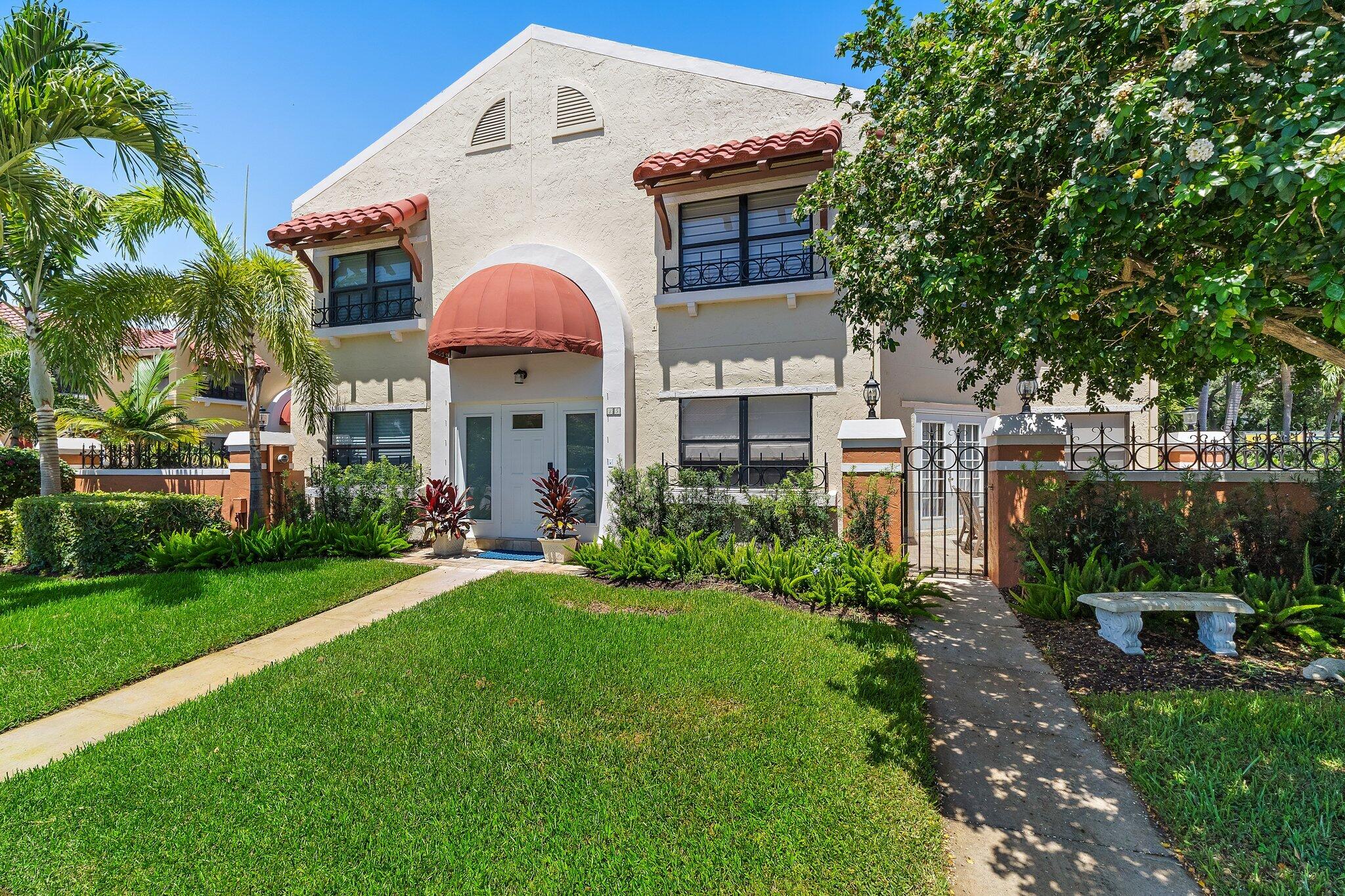 15 Uno Lago Drive, Unit 15 Juno Beach, FL 33408 - Photo 3 of 50 a view of a house with a yard and sitting area
