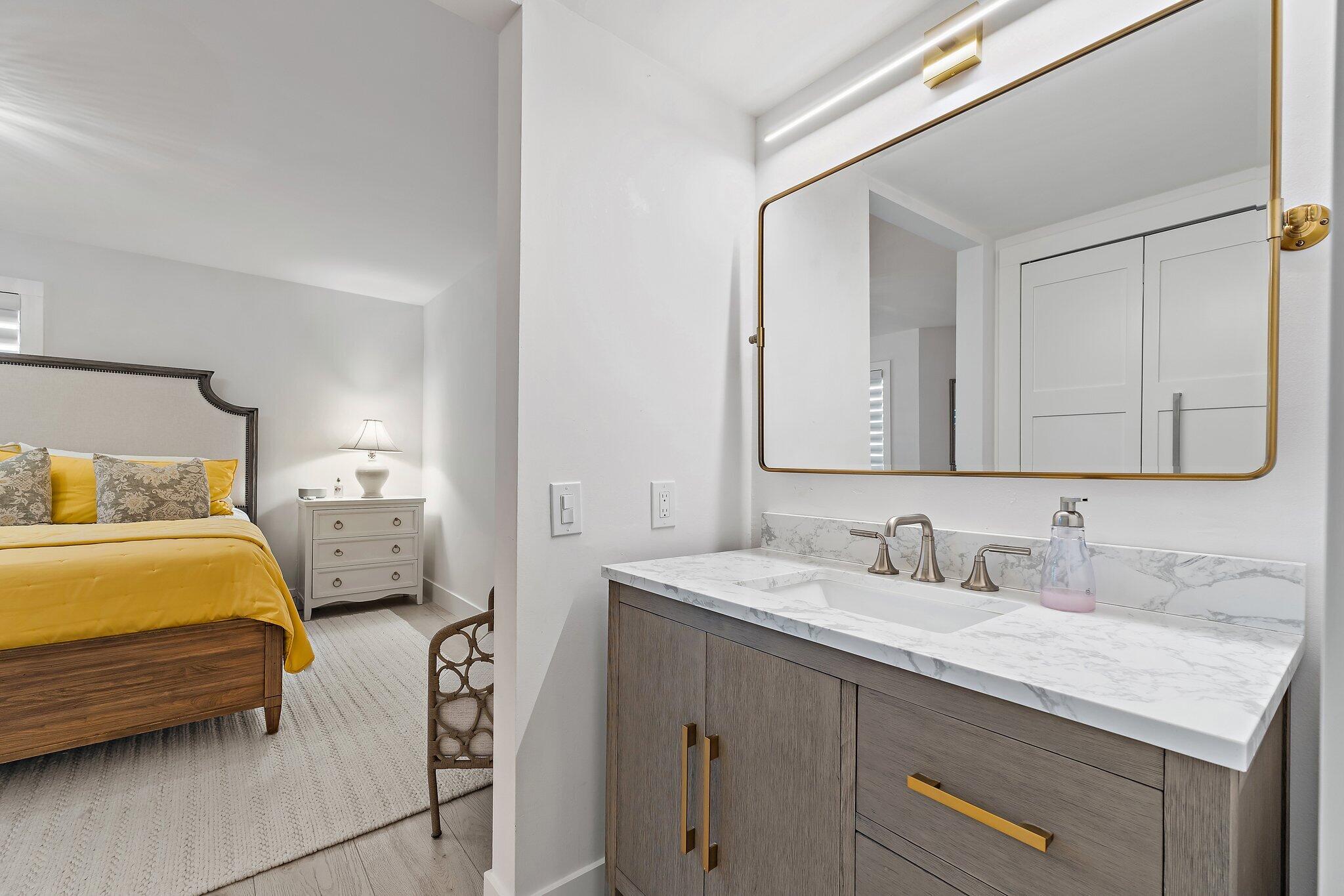 15 Uno Lago Drive, Unit 15 Juno Beach, FL 33408 - Photo 32 of 50 a en suite bathroom with a sink and a mirror