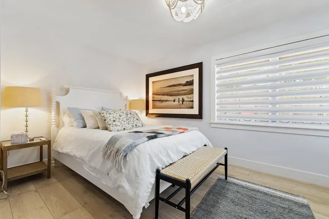 a spacious bedroom with a bed and a window