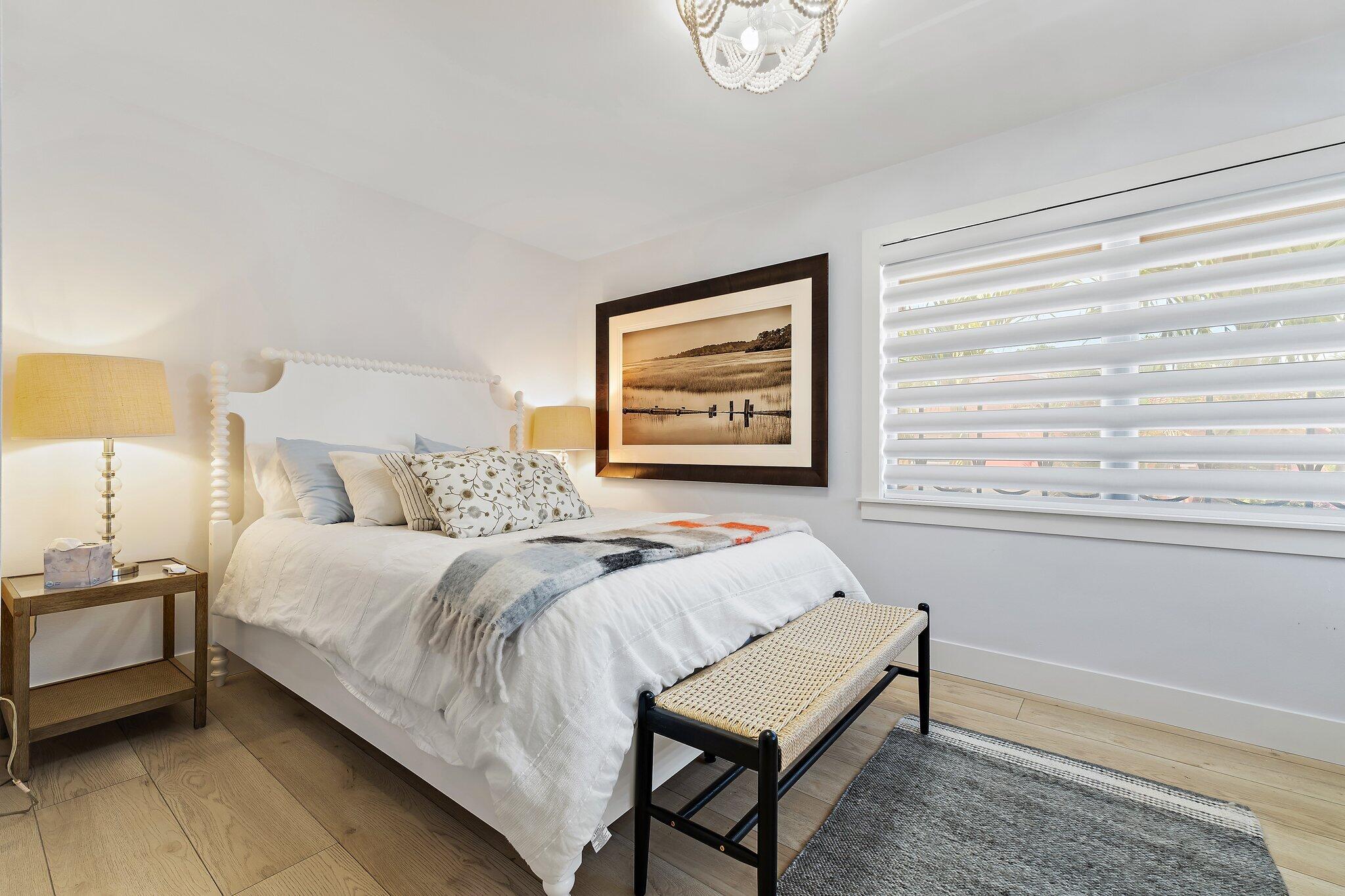 15 Uno Lago Drive, Unit 15 Juno Beach, FL 33408 - Photo 33 of 50 a spacious bedroom with a bed and a window