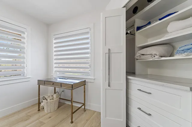 a room with a wooden floor and cabinets