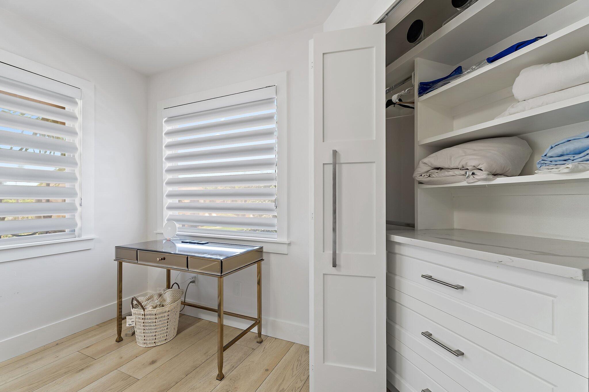 15 Uno Lago Drive, Unit 15 Juno Beach, FL 33408 - Photo 34 of 50 a room with a wooden floor and cabinets