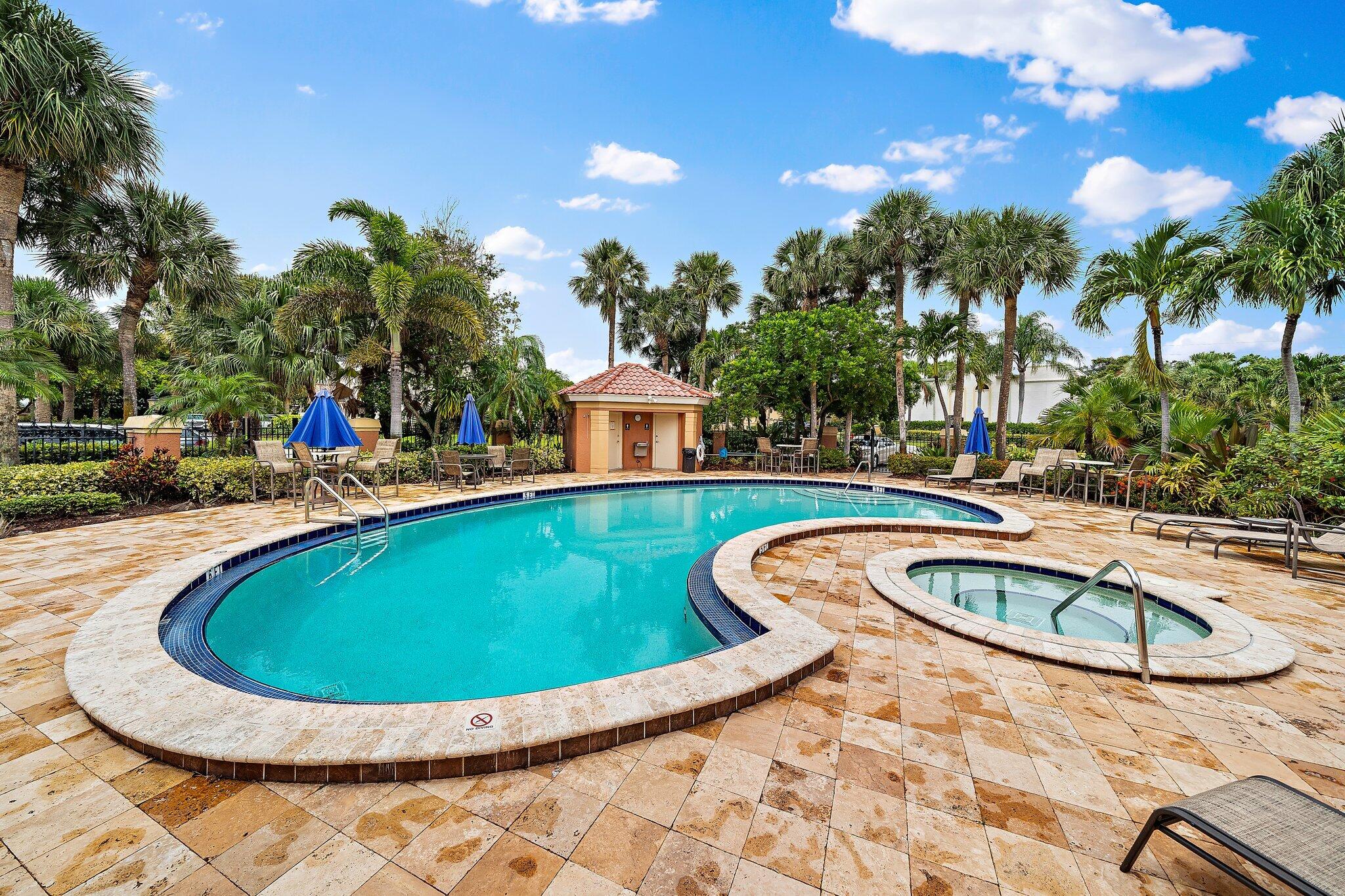 15 Uno Lago Drive, Unit 15 Juno Beach, FL 33408 - Photo 39 of 50 a view of outdoor space yard swimming pool and outdoor seating