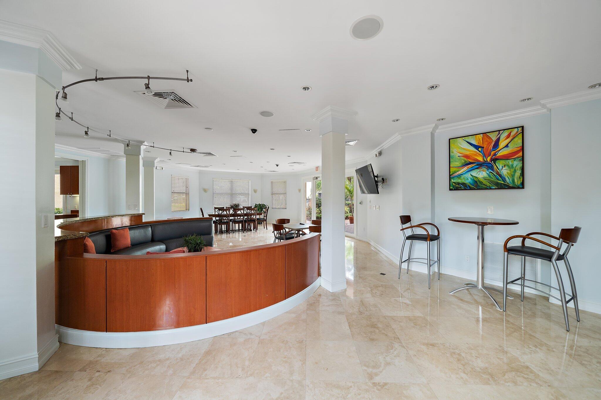 15 Uno Lago Drive, Unit 15 Juno Beach, FL 33408 - Photo 41 of 50 a view of a kitchen with kitchen island stainless steel appliances a stove a table and chairs