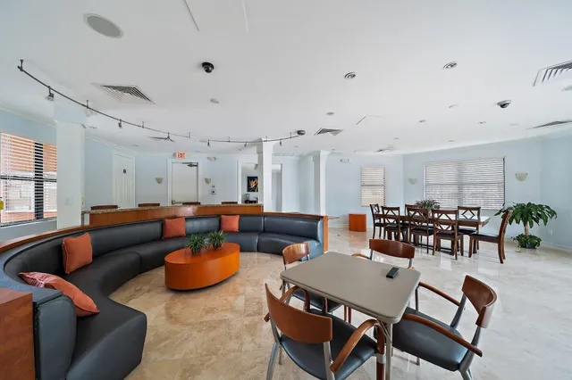 a living room with furniture a dining table and chairs