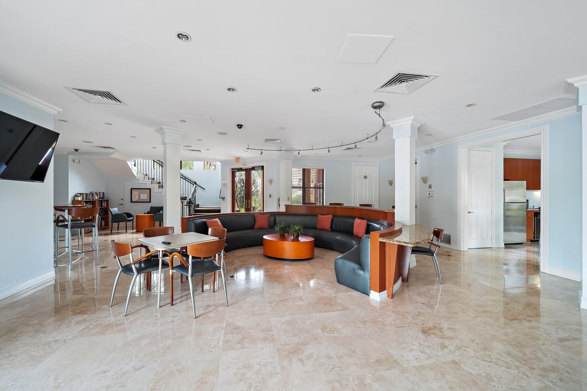 15 Uno Lago Drive, Unit 15 Juno Beach, FL 33408 - Photo 45 of 50 a room with lots of furniture and clutter