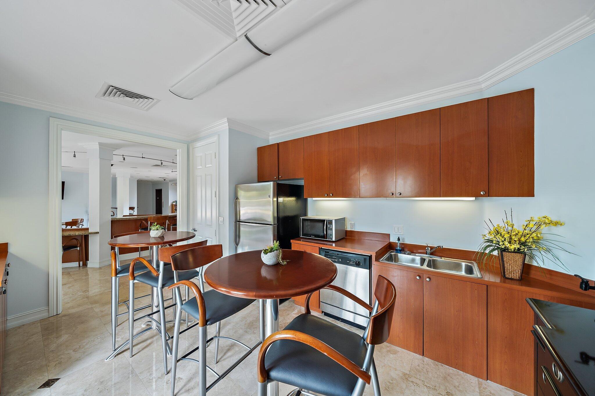 15 Uno Lago Drive, Unit 15 Juno Beach, FL 33408 - Photo 47 of 50 a dining room with furniture and wooden floor