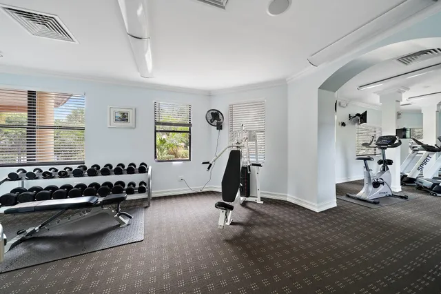 a room with gym equipment and windows