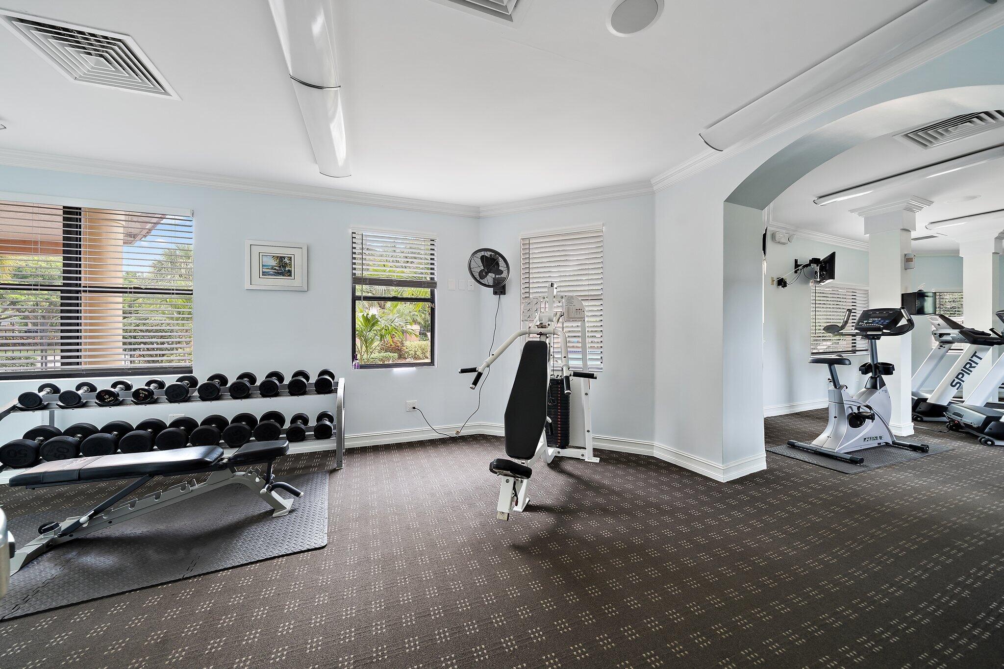 15 Uno Lago Drive, Unit 15 Juno Beach, FL 33408 - Photo 48 of 50 a room with gym equipment and windows