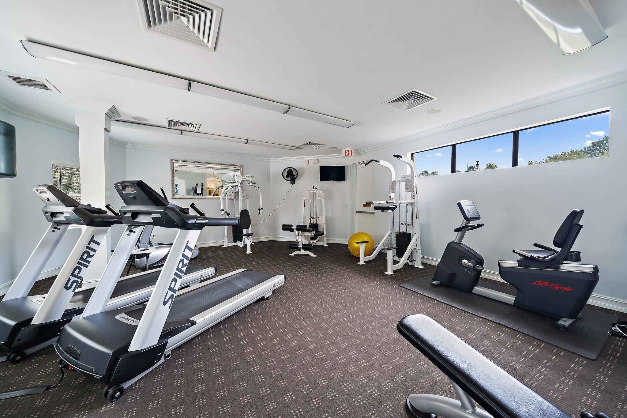 15 Uno Lago Drive, Unit 15 Juno Beach, FL 33408 - Photo 49 of 50 a view of a room with gym equipment