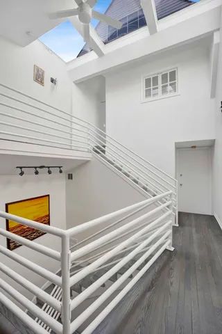 a view of room with stairs and a ceiling fan