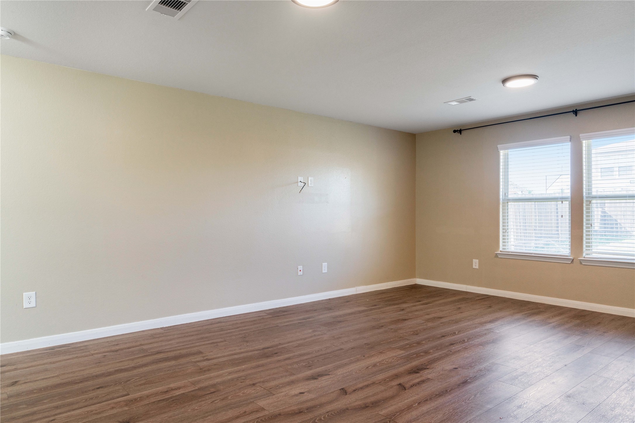 10011 Orchid Spring Lane Houston, TX 77044 - Photo 14 of 42 a view of an empty room with wooden floor and a window