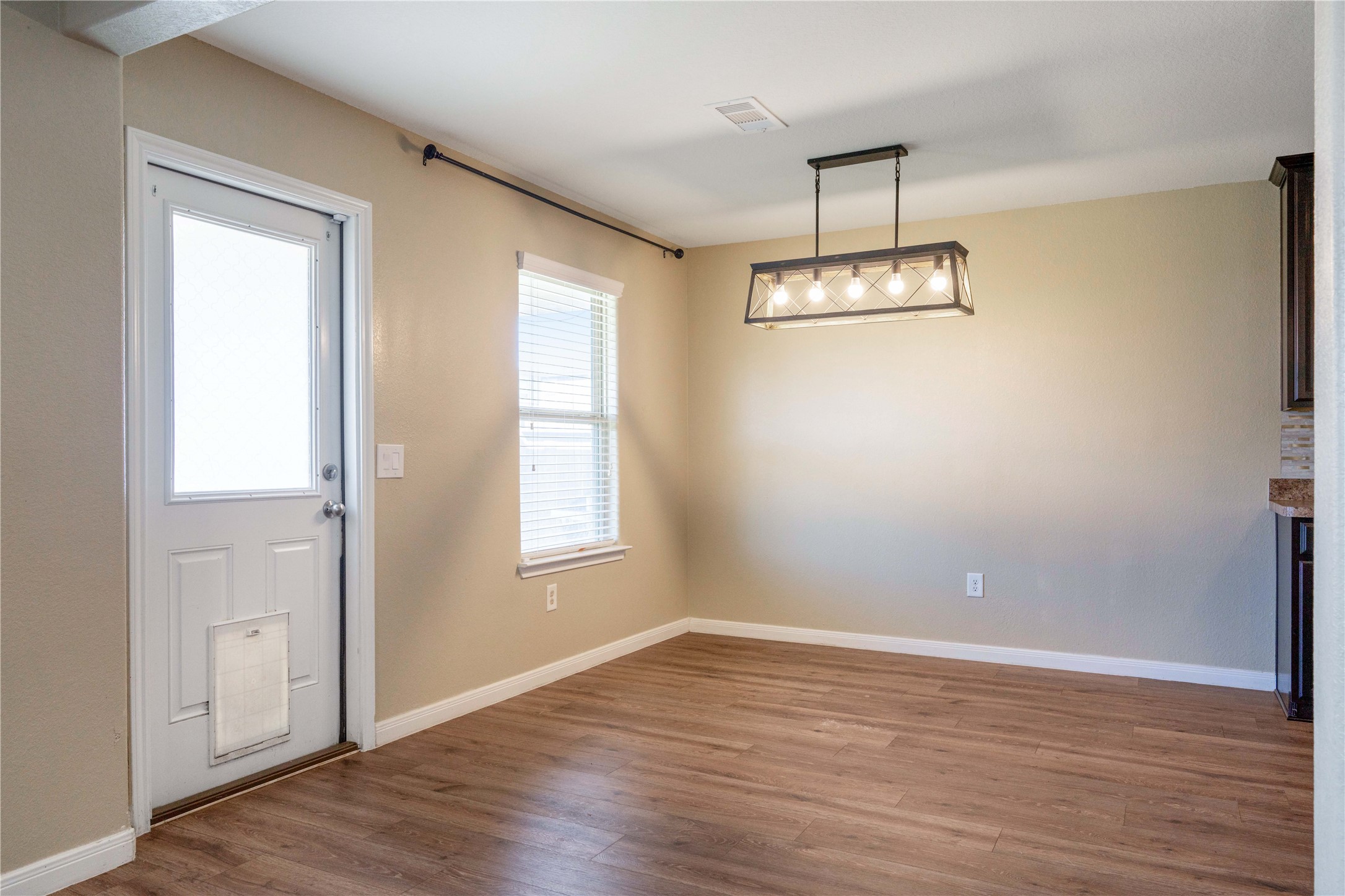 10011 Orchid Spring Lane Houston, TX 77044 - Photo 15 of 42 a view of an empty room with wooden floor and a window
