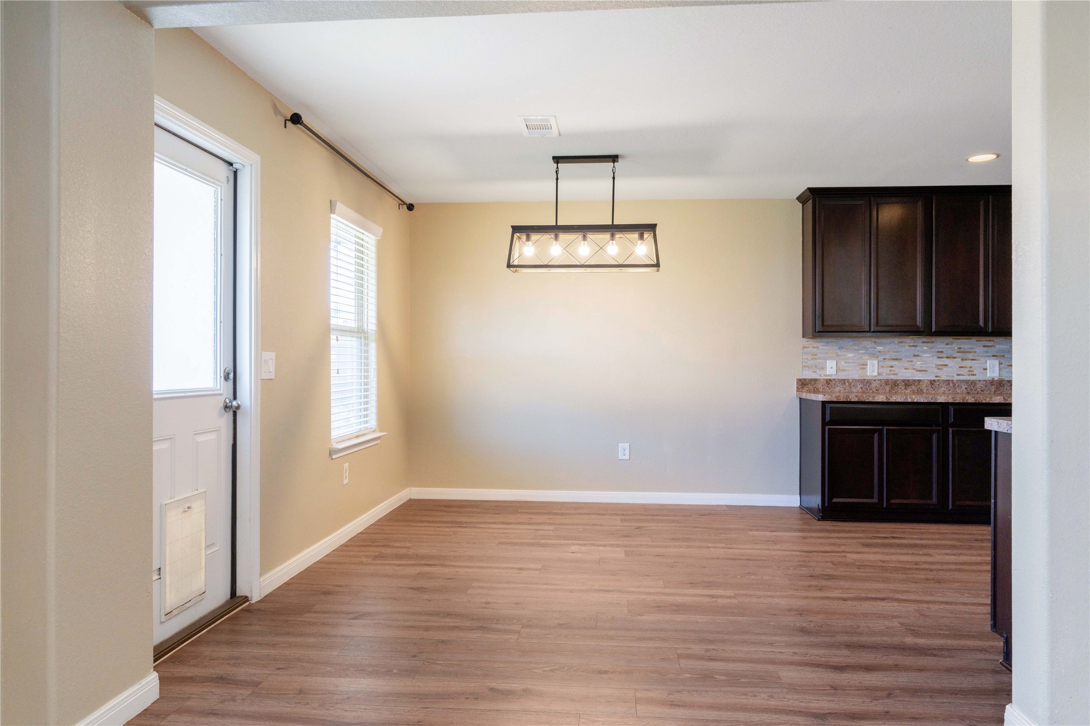 10011 Orchid Spring Lane Houston, TX 77044 - Photo 16 of 42 a view of an empty room with wooden floor and a window