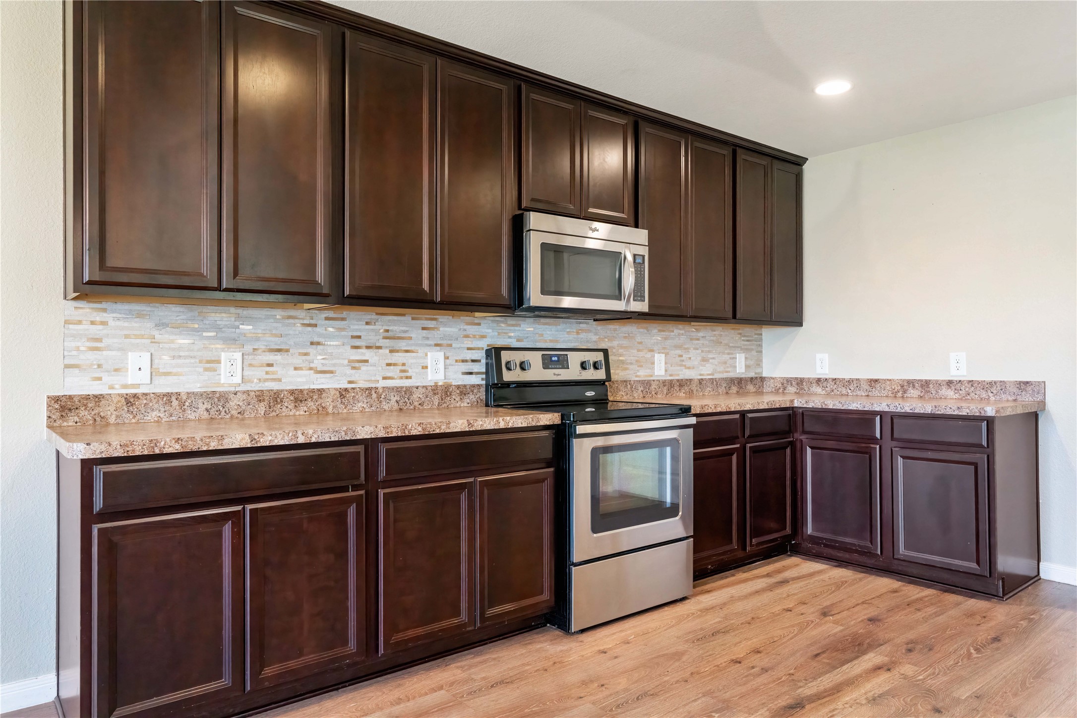 10011 Orchid Spring Lane Houston, TX 77044 - Photo 21 of 42 a kitchen with granite countertop stainless steel appliances wooden cabinets and granite counter tops