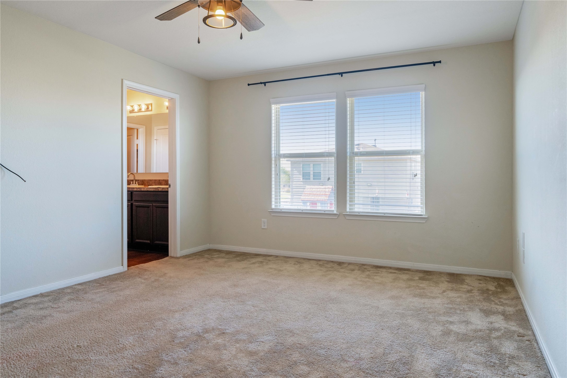 10011 Orchid Spring Lane Houston, TX 77044 - Photo 25 of 42 an empty room with chandelier fan and windows