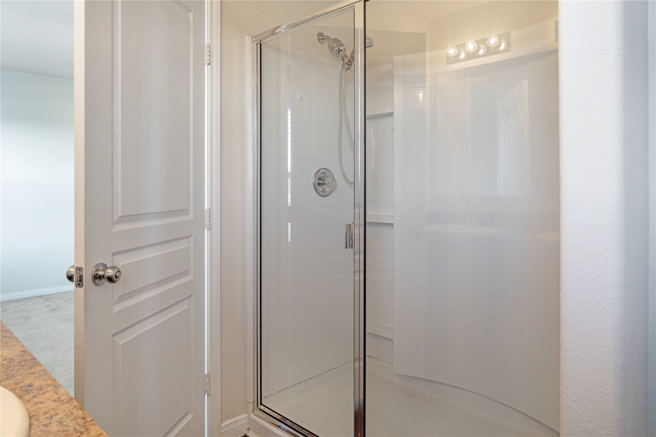 10011 Orchid Spring Lane Houston, TX 77044 - Photo 29 of 42 a bathroom with a glass shower door